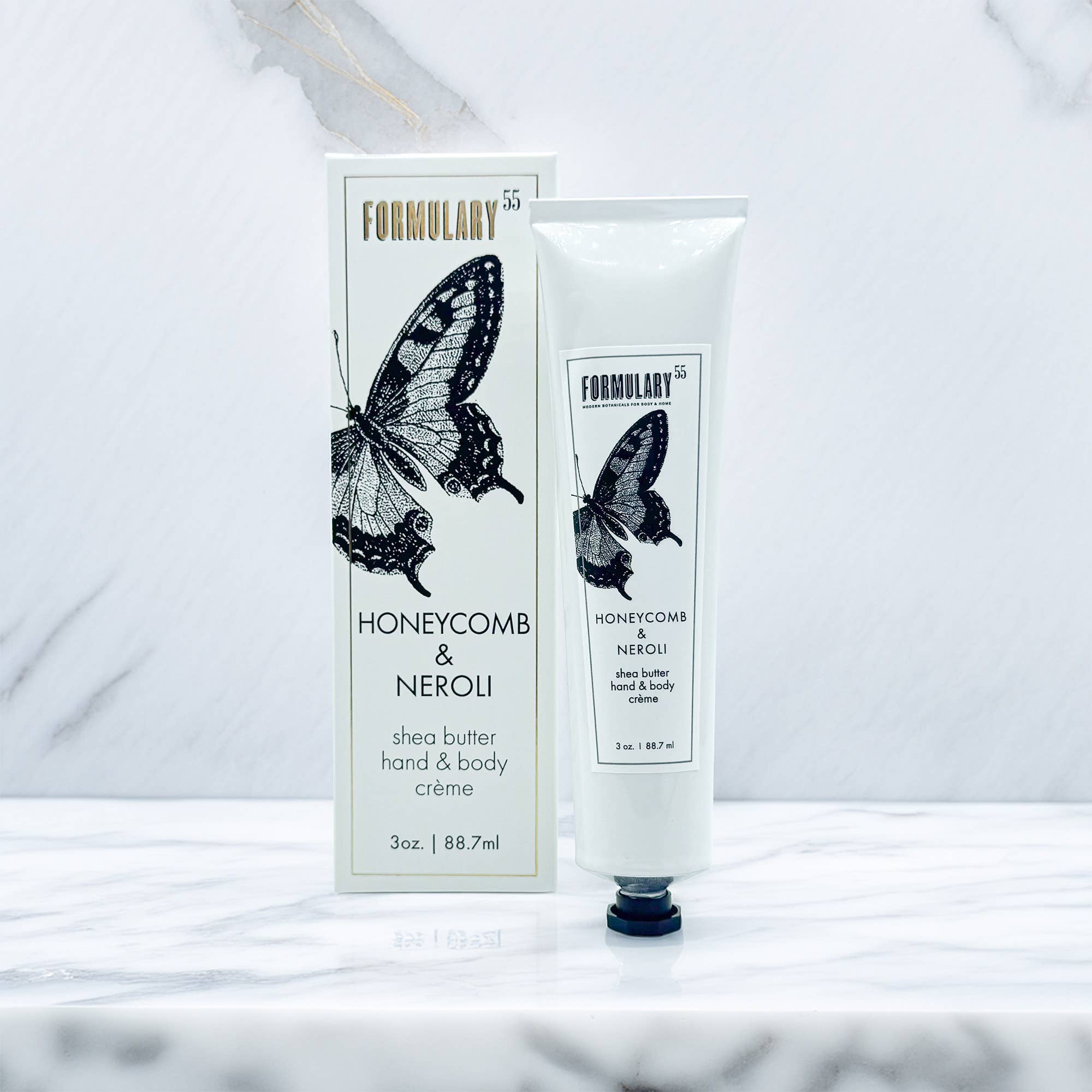 Shea butter hand and body crème with packaging featuring a butterfly design on a white background