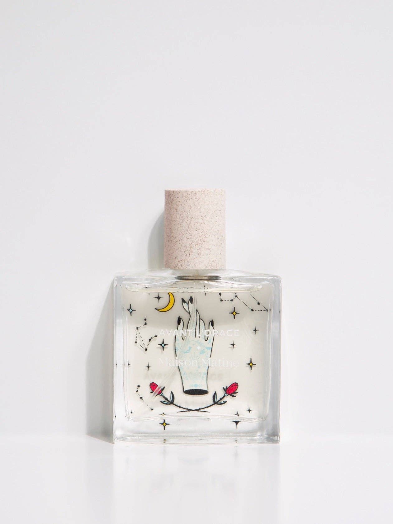Clear bottle with decorative label and cork stopper on a white background