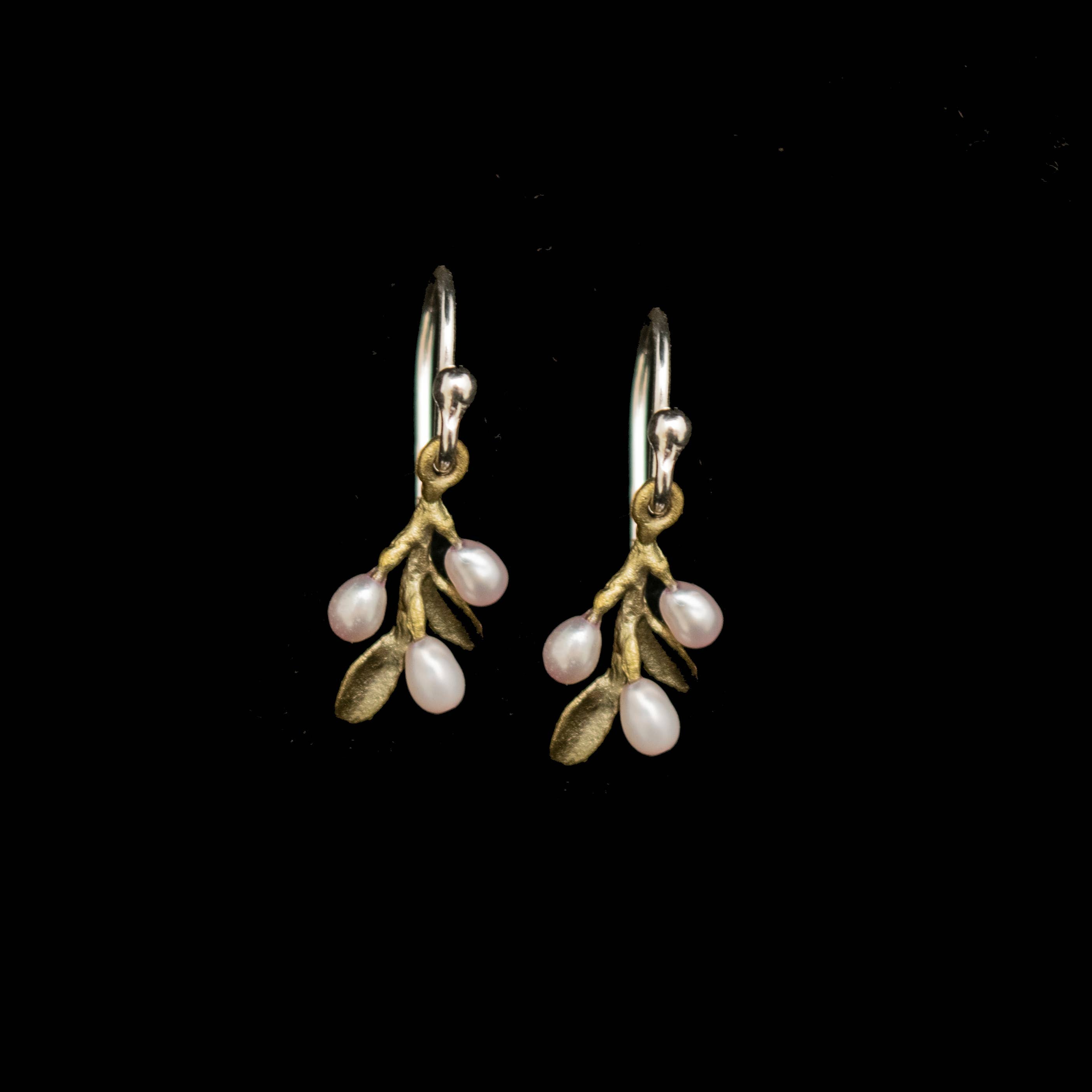 Pair of earrings with floral design on a black background