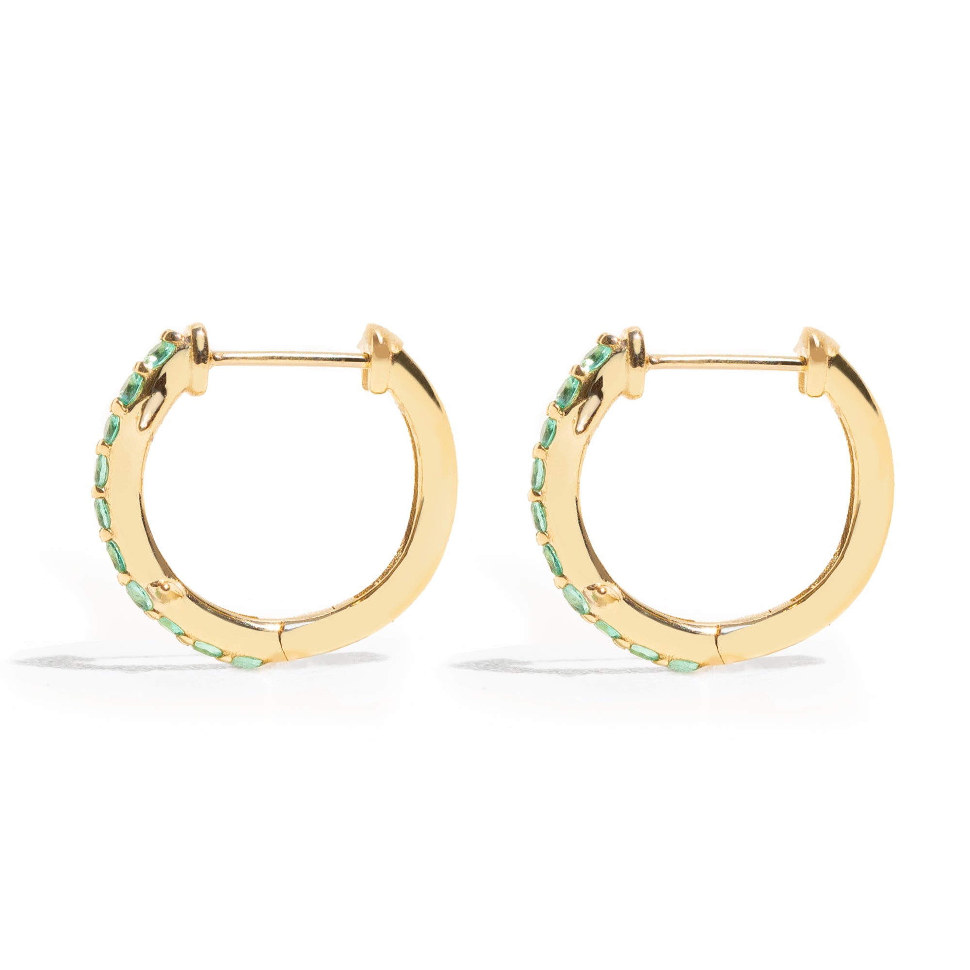 Thorn_Hoops_Emerald_Bold yet refined, the Thorn Emerald Hoop features a delicate thorn silhouette accented with vibrant emeralds. Edgy and elegant, it’s designed for those who love a touch of drama in an understated form.