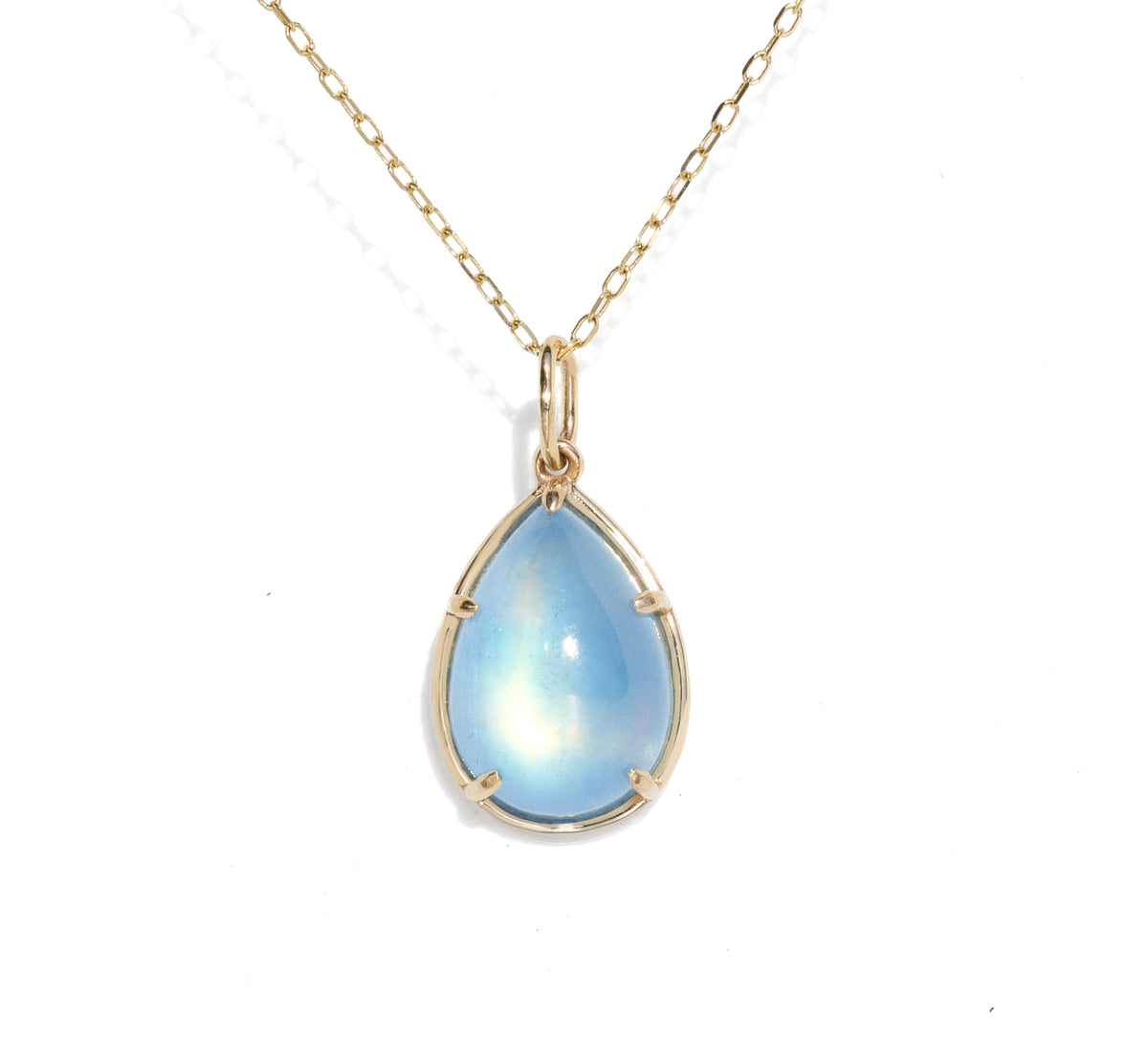 A gold teardrop pendant necklace featuring a light blue iridescent moonstone gemstone, suspended from a delicate gold chain on a white background.