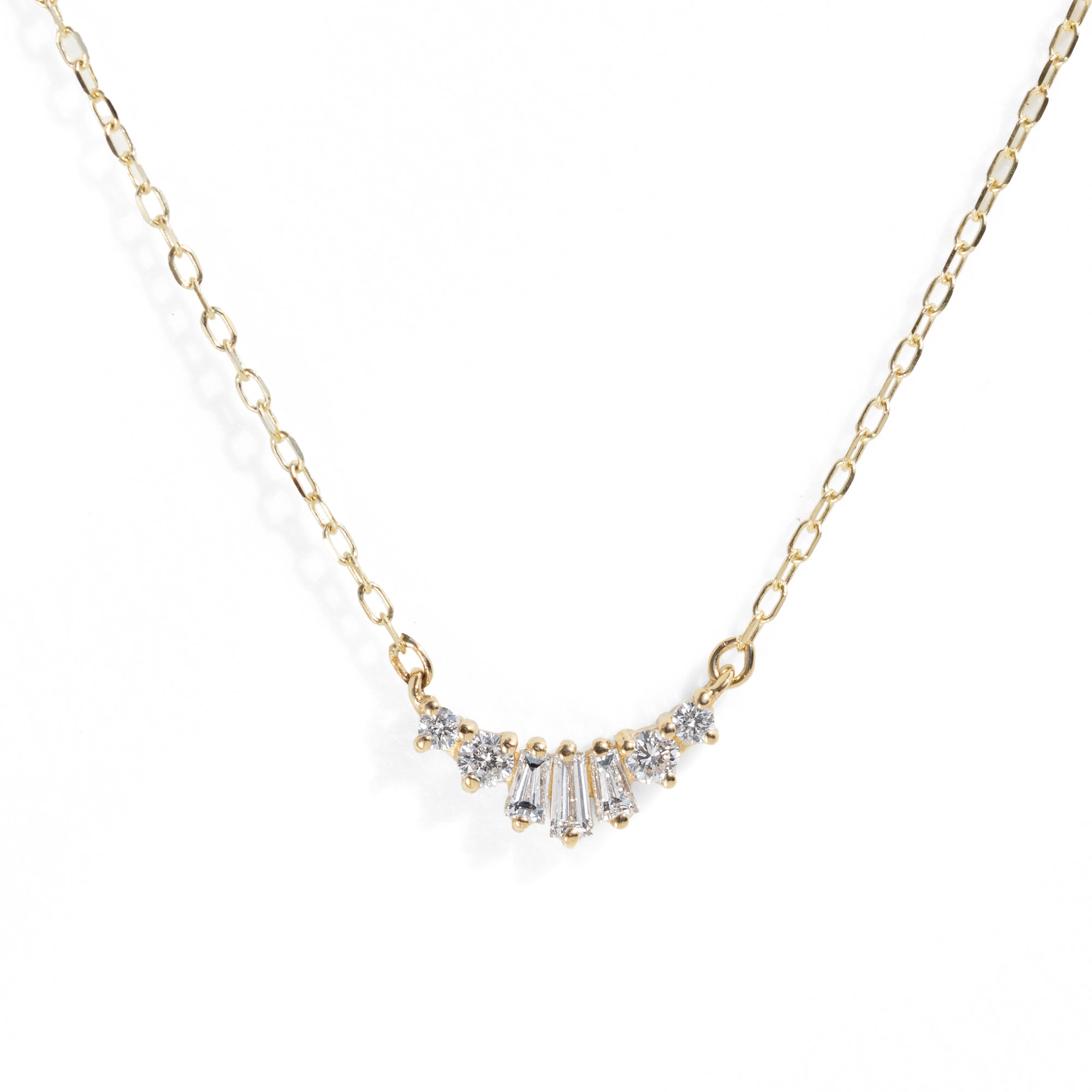 Gold necklace with diamond pendant on a white background