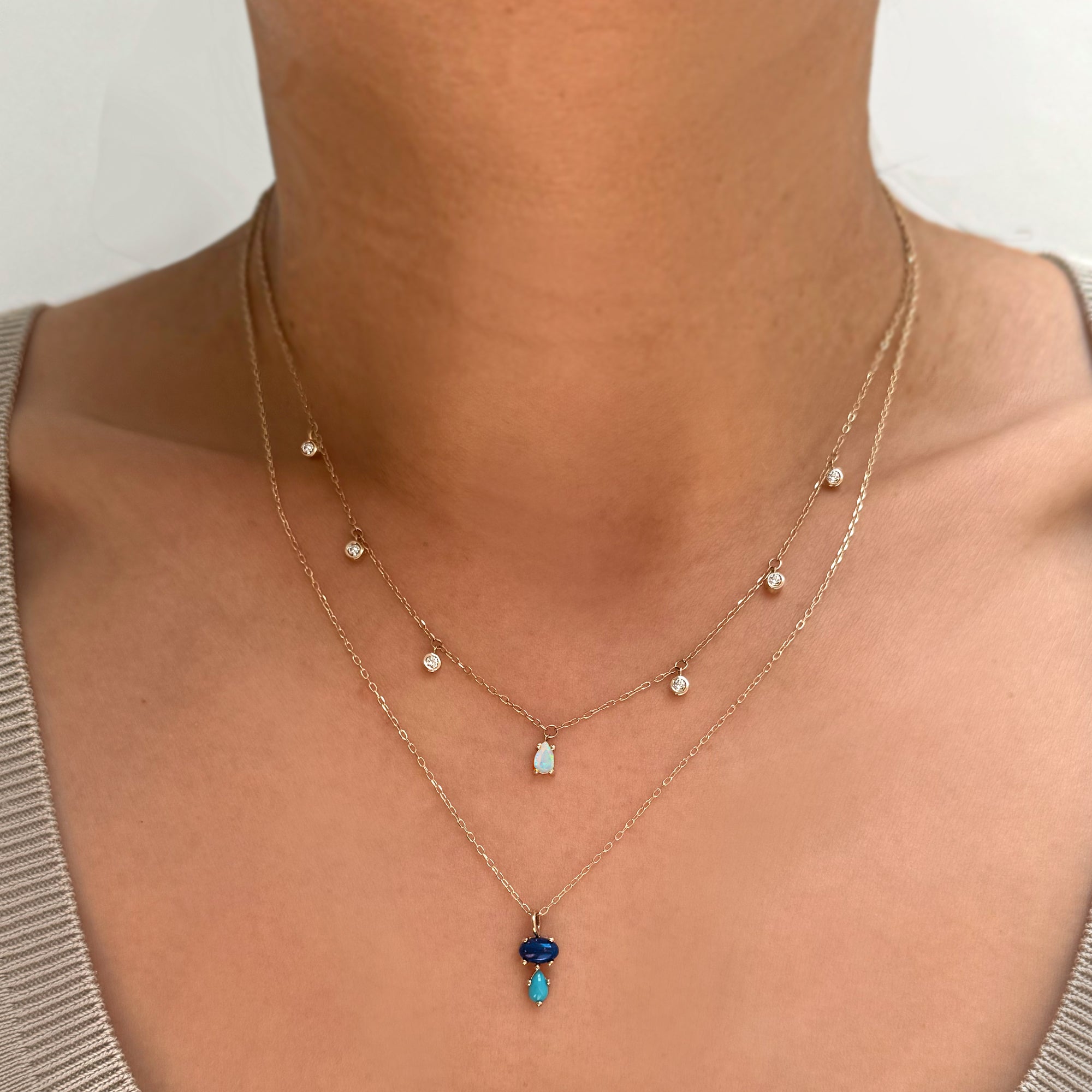 Add a vibrant touch of color with our Bubble Drop Necklace, featuring an oval lapis lazuli and a pear-cut turquoise, set in solid 14K gold. Inspired by the beauty of a cool summer night by the beach, this delicate blue gemstone necklace evokes the deep blue sky above the clear ocean. Perfect for everyday wear or as a thoughtful gift.