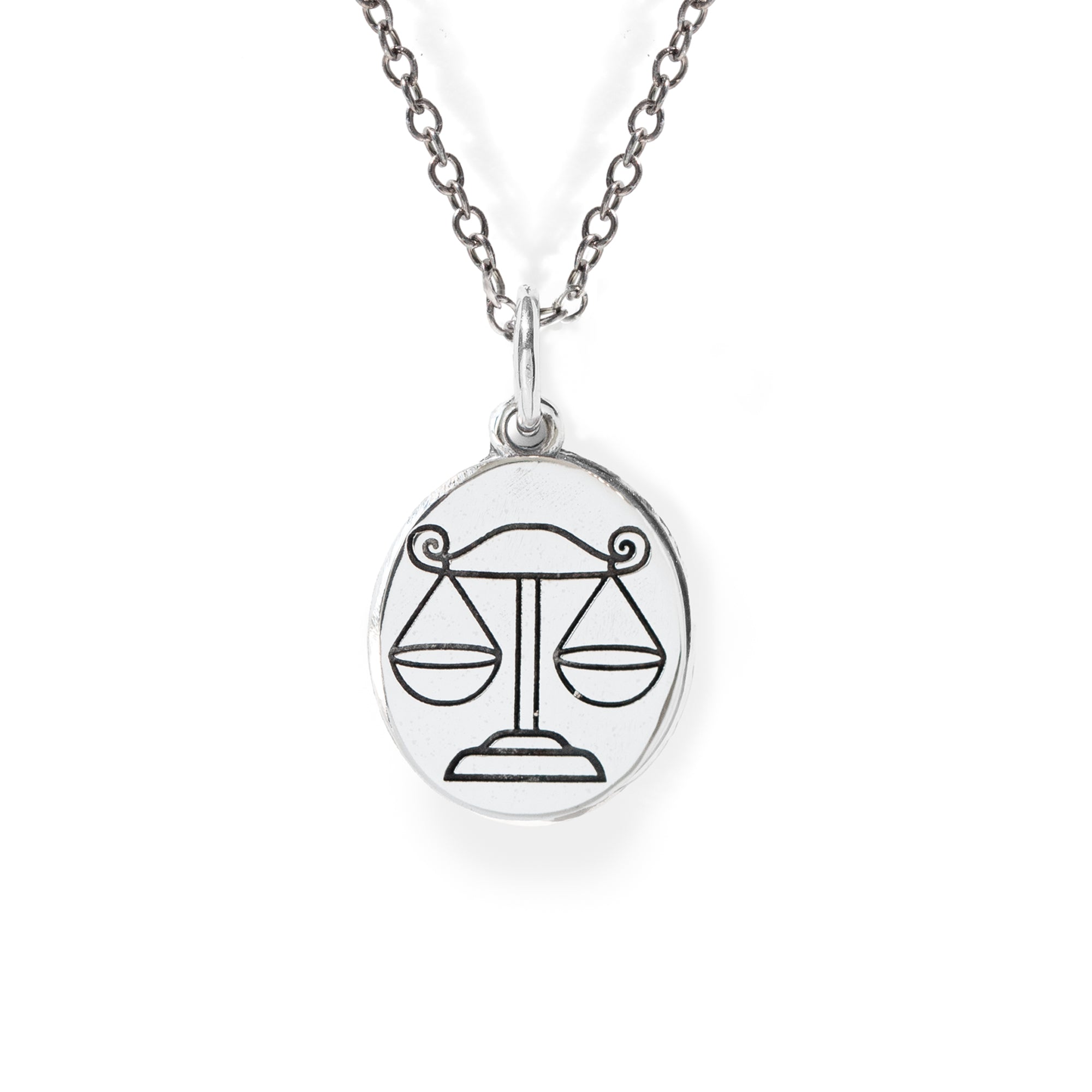 Silver necklace with a Libra zodiac sign pendant on a white background