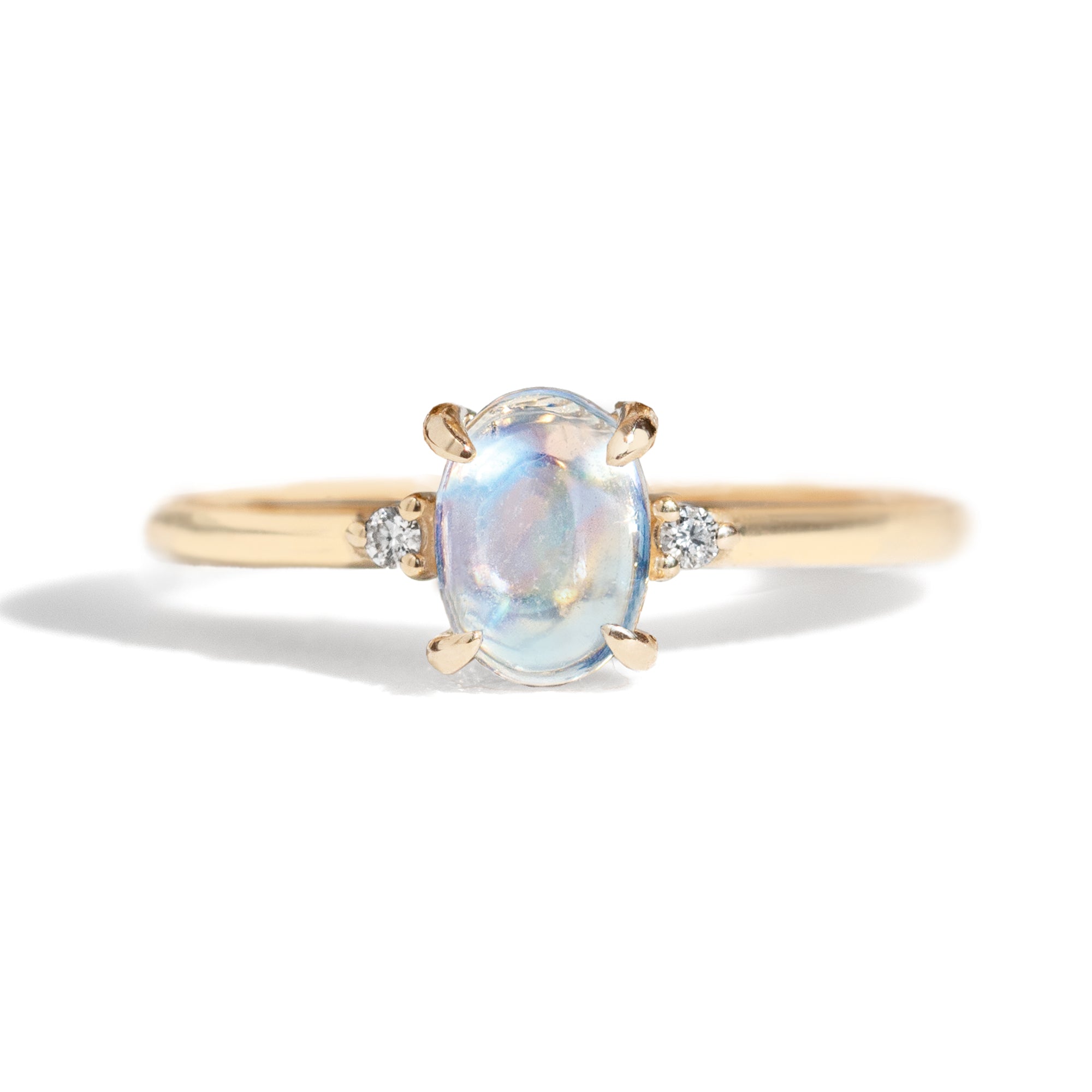 The classic Grace Ring's three stone design makes it perfect for your special day. This unique ring features an oval rainbow moonstone adorned with small diamonds, making it a truly one-of-a-kind piece. Pair this ring with Blossom Moonstone Contour Band to create your dream ring stack. 