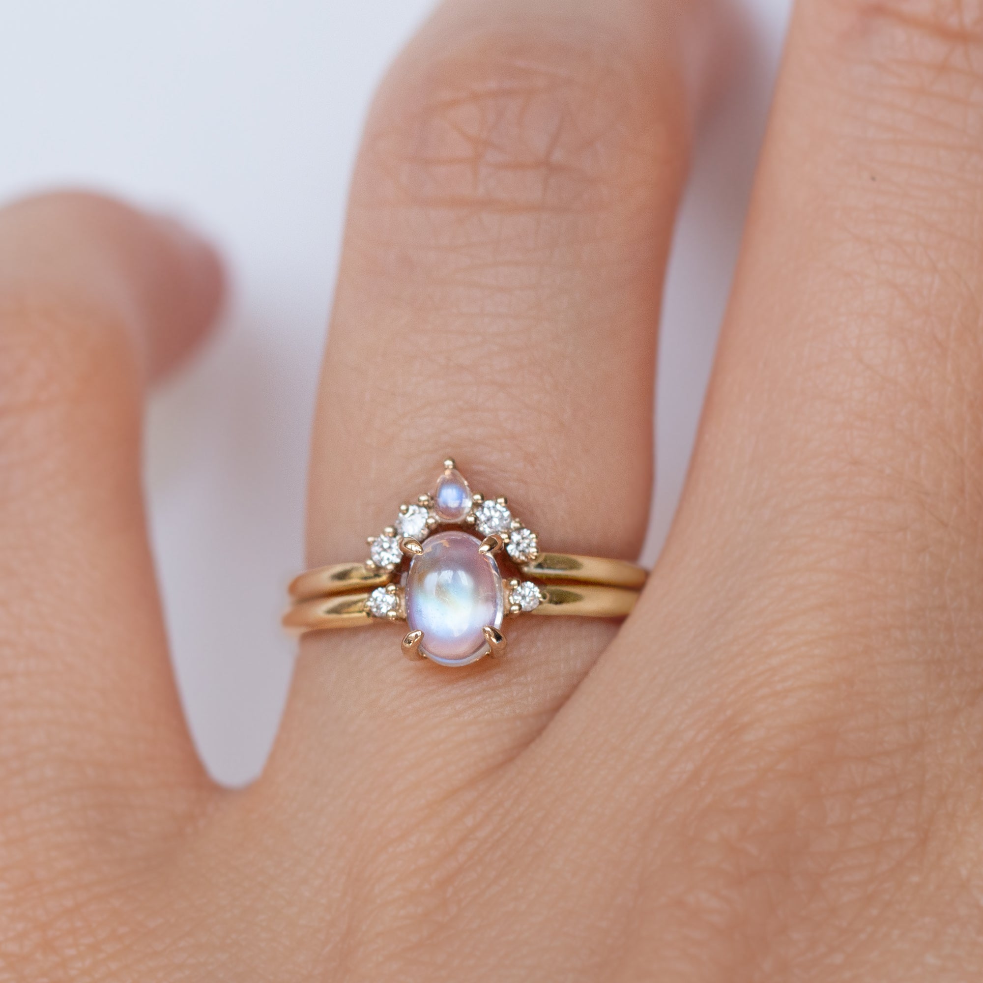 The classic Grace Ring's three stone design makes it perfect for your special day. This unique ring features an oval rainbow moonstone adorned with small diamonds, making it a truly one-of-a-kind piece. Pair this ring with Blossom Moonstone Contour Band to create your dream ring stack. 