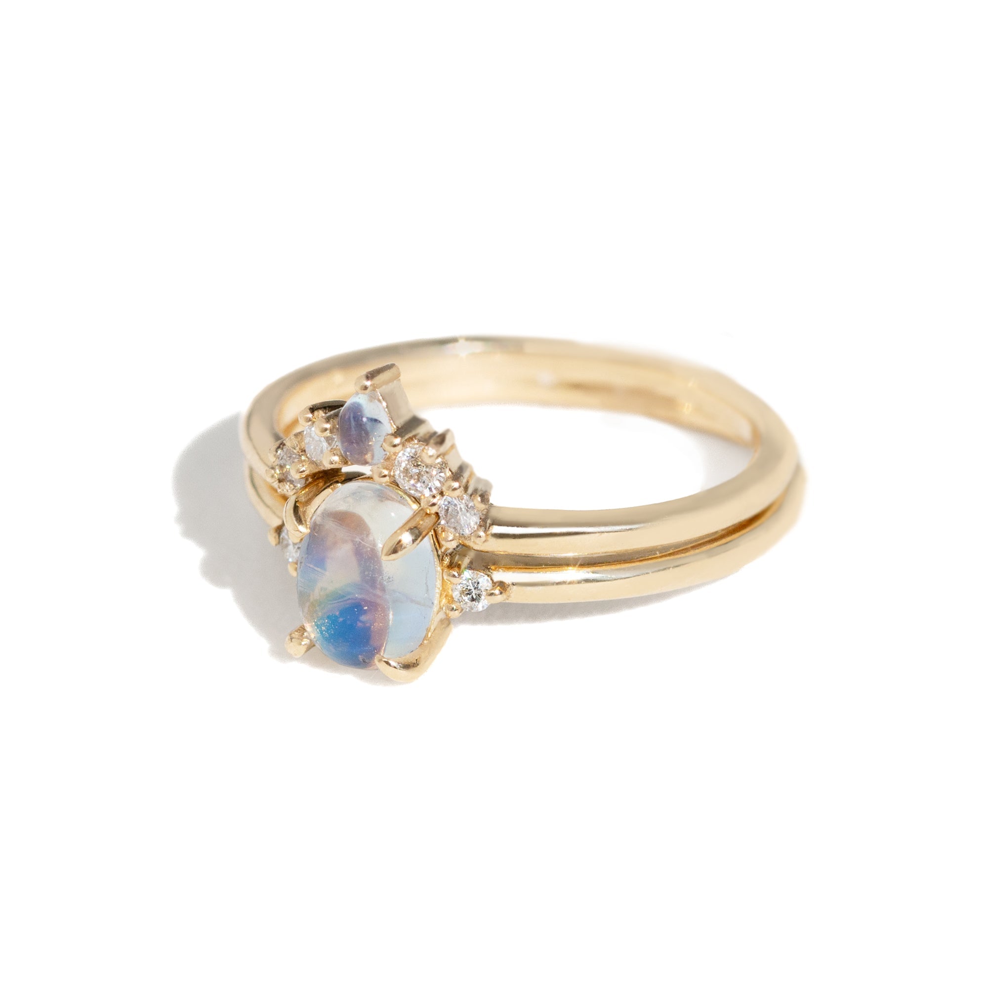 The classic Grace Ring's three stone design makes it perfect for your special day. This unique ring features an oval rainbow moonstone adorned with small diamonds, making it a truly one-of-a-kind piece. Pair this ring with Blossom Moonstone Contour Band to create your dream ring stack. 