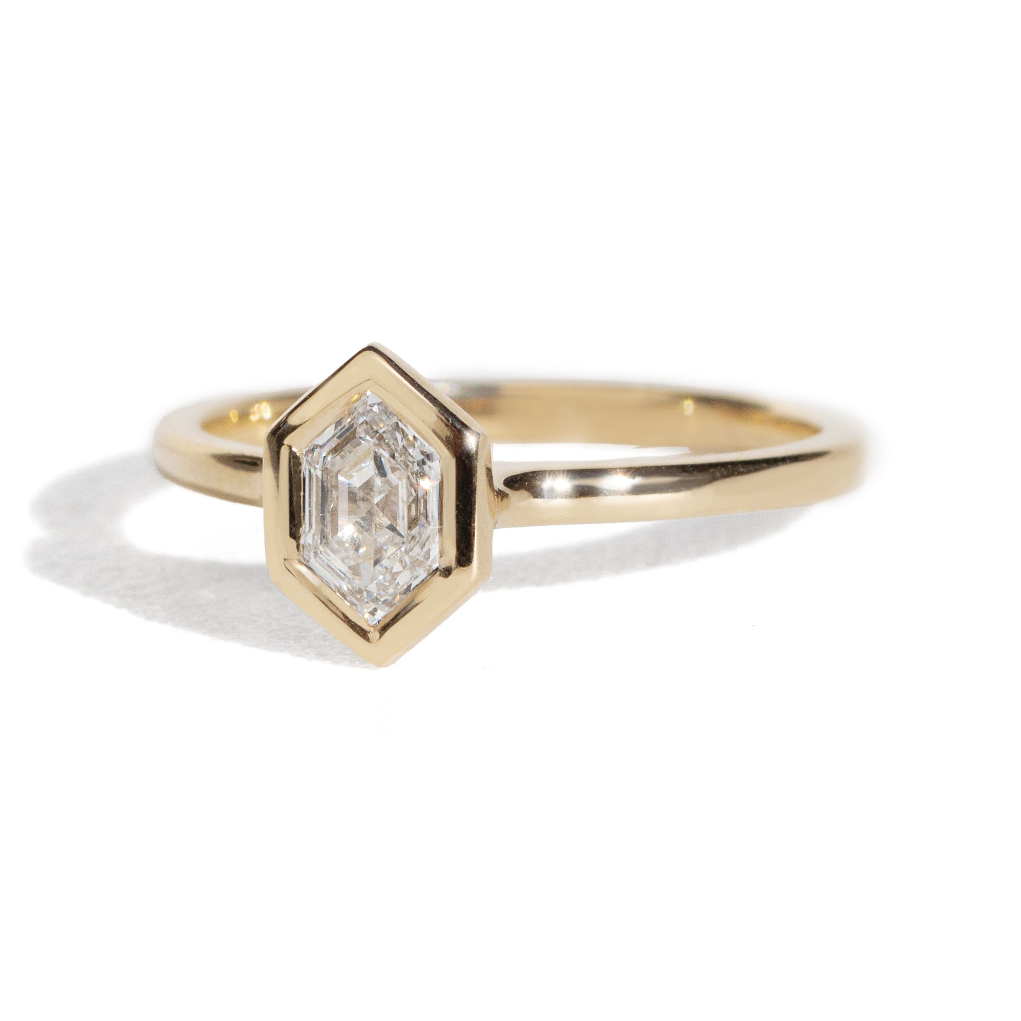 Gold ring with a diamond on a white background