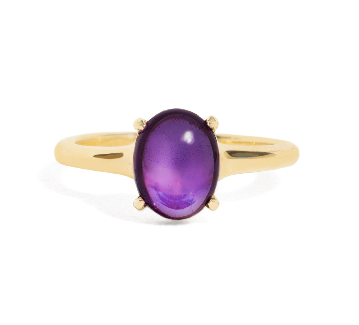 Gold ring with a purple gemstone on a white background