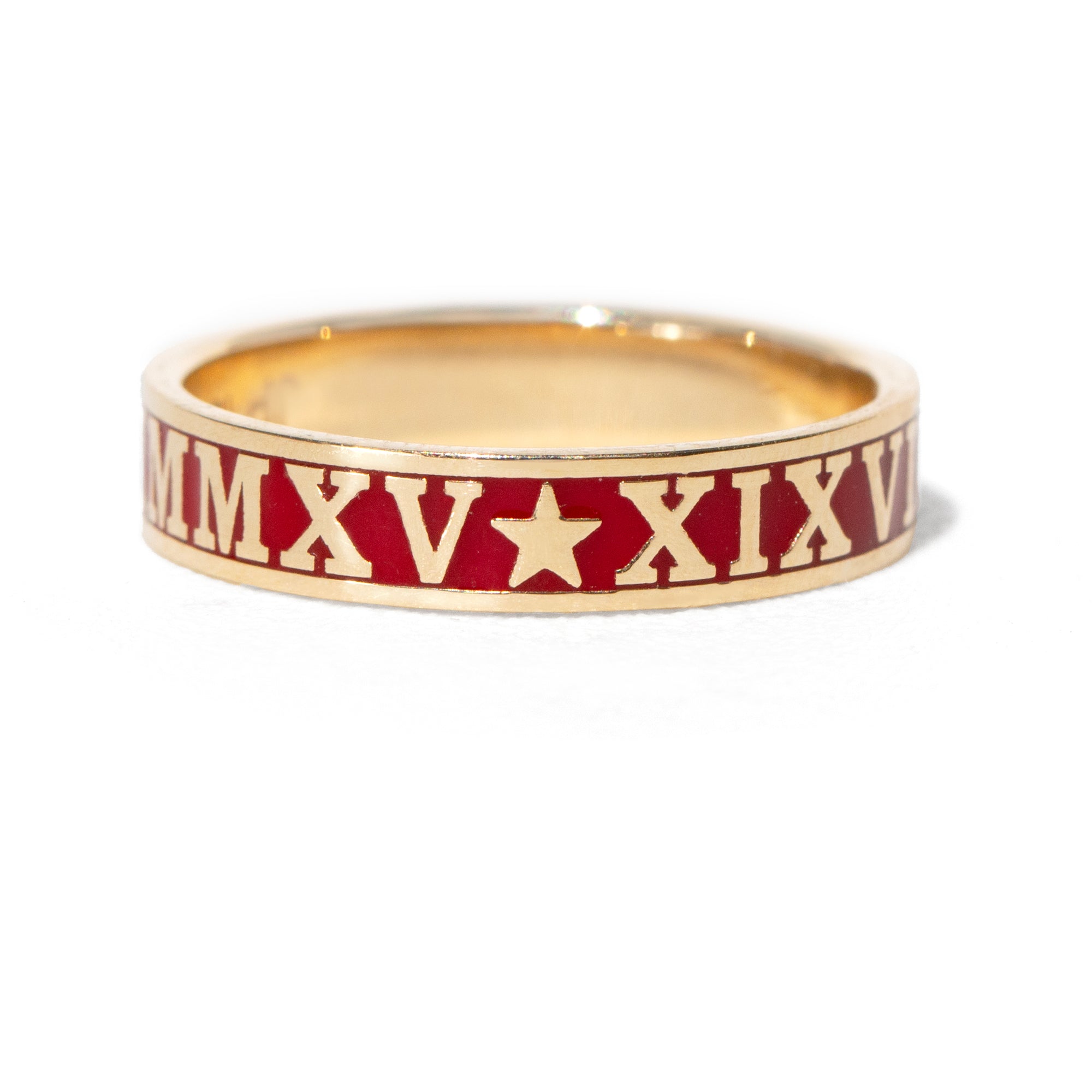 Gold ring with red band featuring Roman numerals and a star on a white background