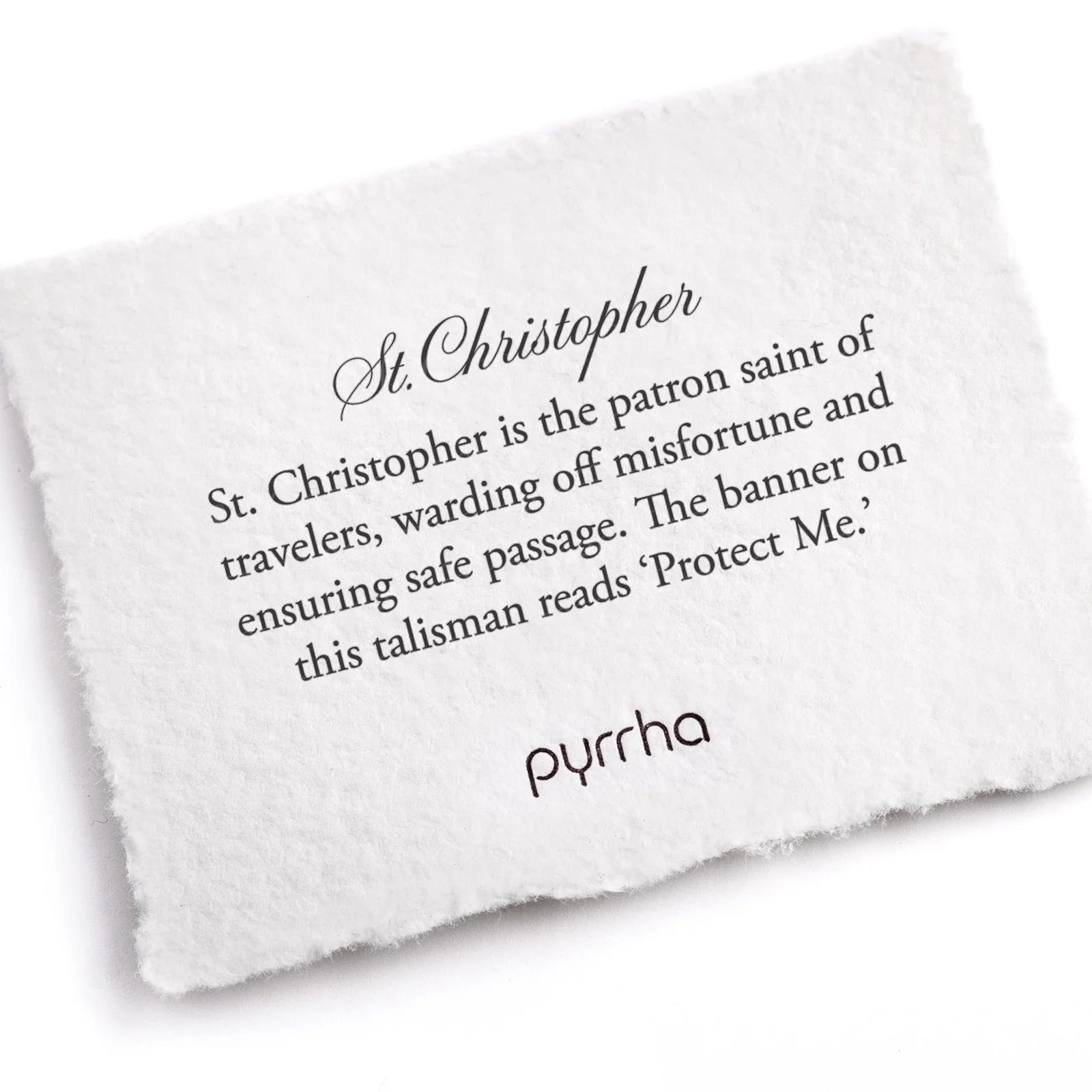 White pillow with text about St. Christopher and branding on a white background