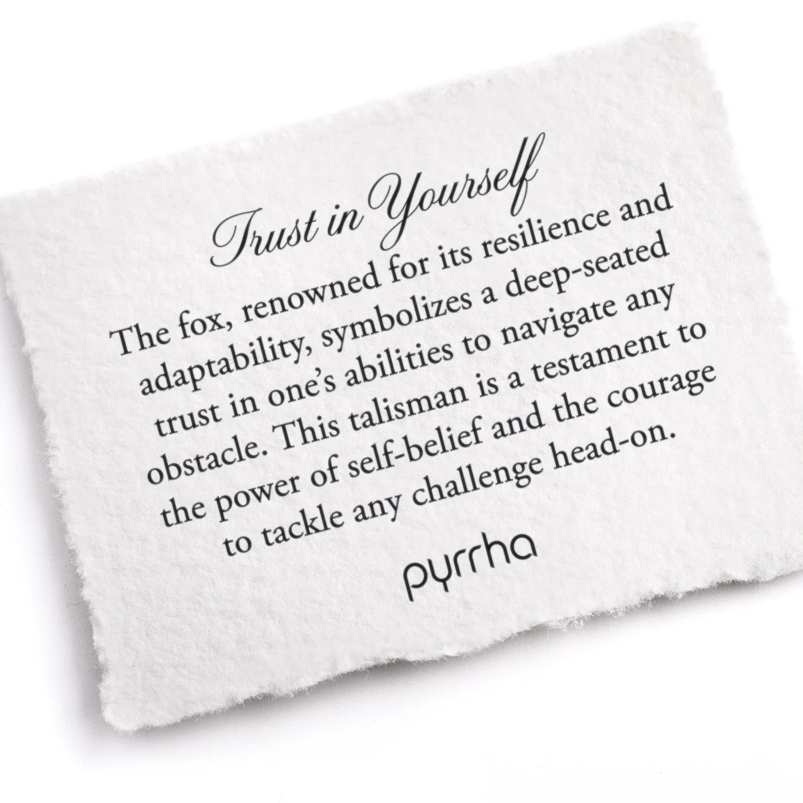 White stone with engraved text and 'pyrrha' branding on a white background