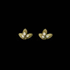 Pair of gold leaf-shaped earrings with pearl centers on a black background