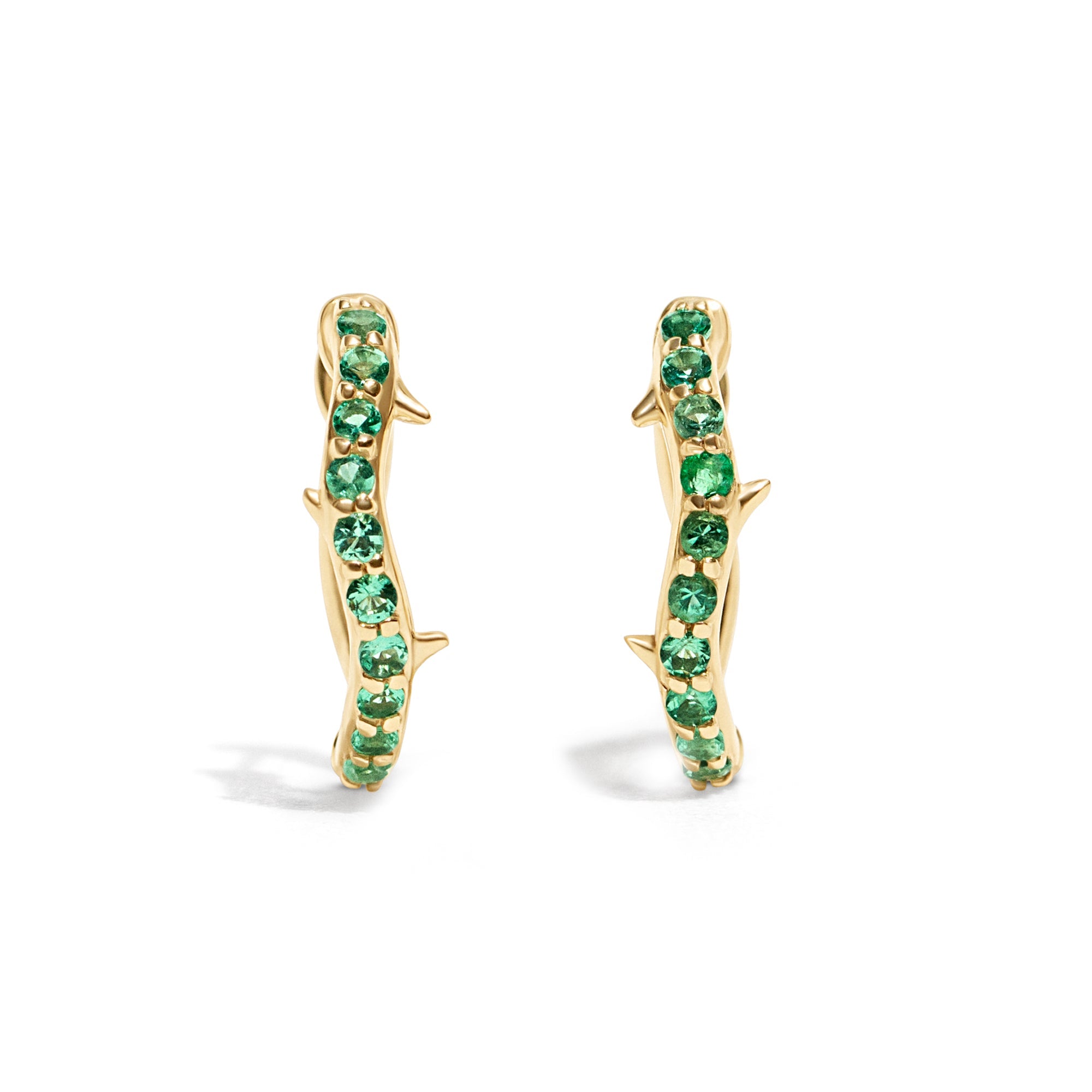 Thorn_Hoops_Emerald_Bold yet refined, the Thorn Emerald Hoop features a delicate thorn silhouette accented with vibrant emeralds. Edgy and elegant, it’s designed for those who love a touch of drama in an understated form.