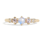 The classic Georgia design makes this five stone ring ideal for everyday wear. This unique ring features a round rainbow moonstone, adorned with natural pink sapphires and diamonds, and exudes mystical purple blue hues, making it a true unicorn piece.