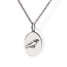 Silver necklace with oval pendant featuring a bird design on a white background