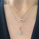 Two gemstone necklaces are worn on a woman.