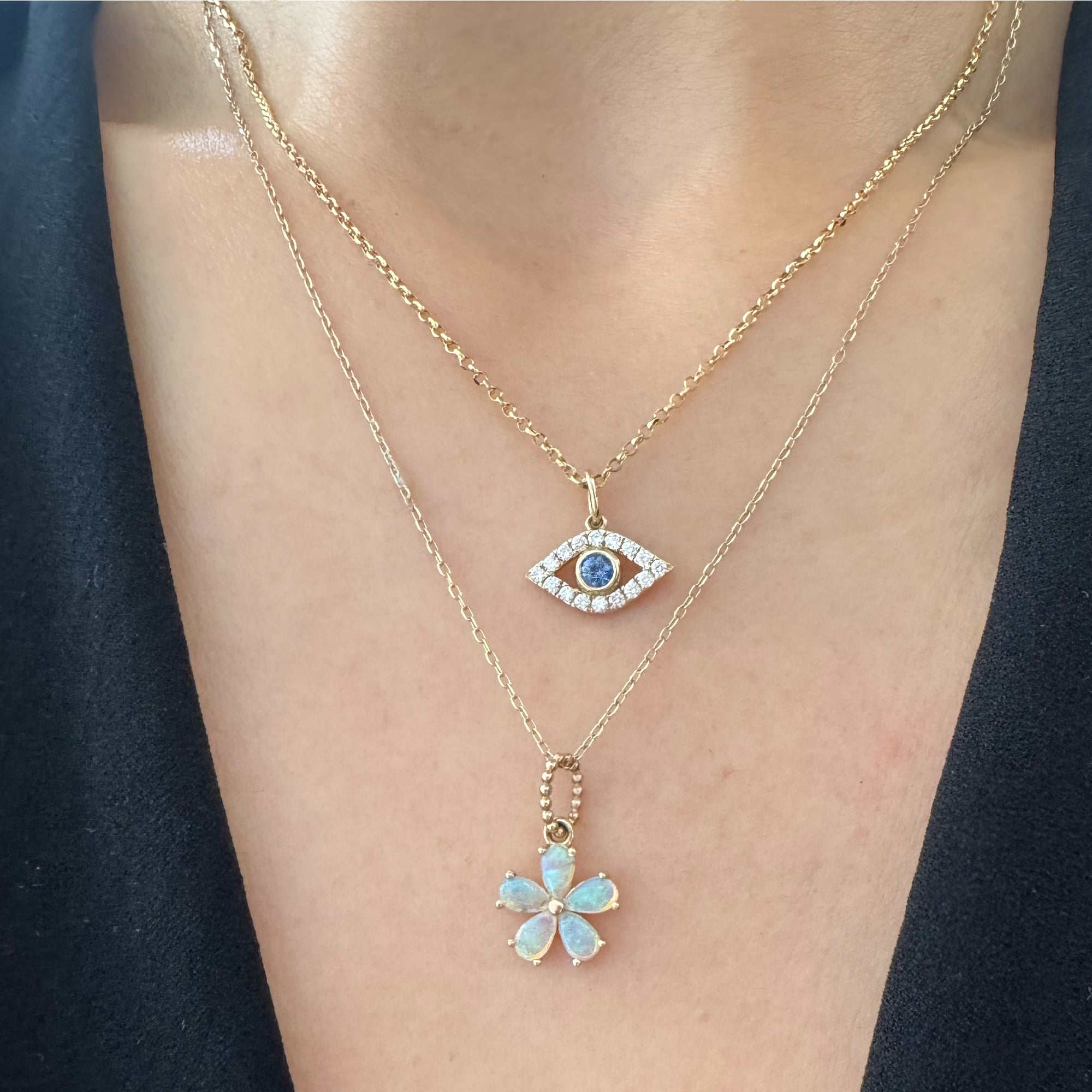 Two gemstone necklaces are worn on a woman.