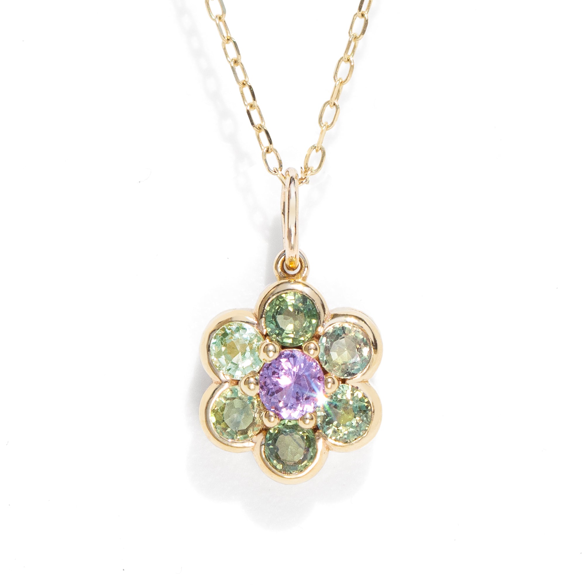 A gemstone necklace in gold color against a white background