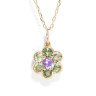 A gemstone necklace in gold color against a white background