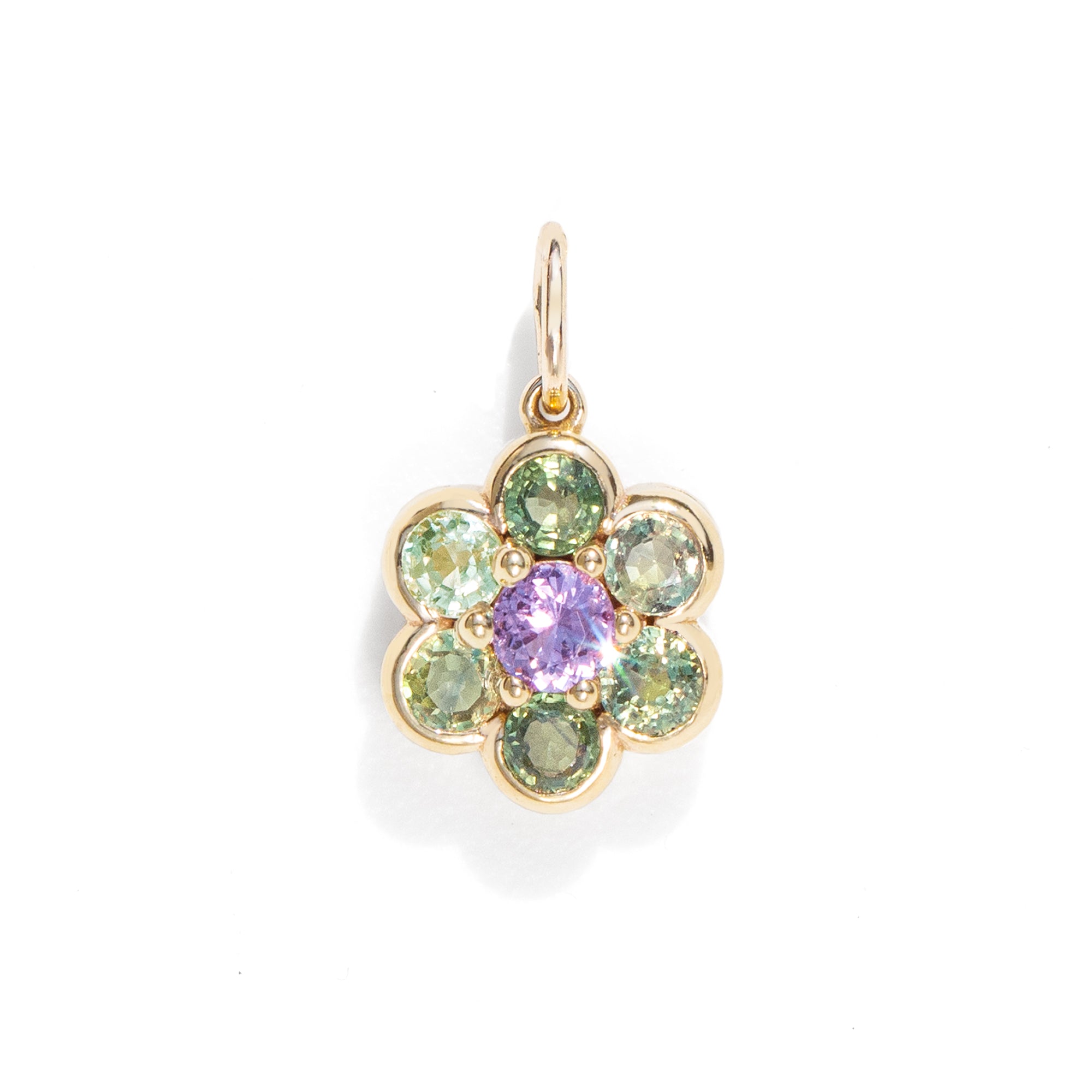 A gemstone charm in gold color against a white background
