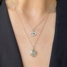 Two gemstone necklaces worn on a woman
