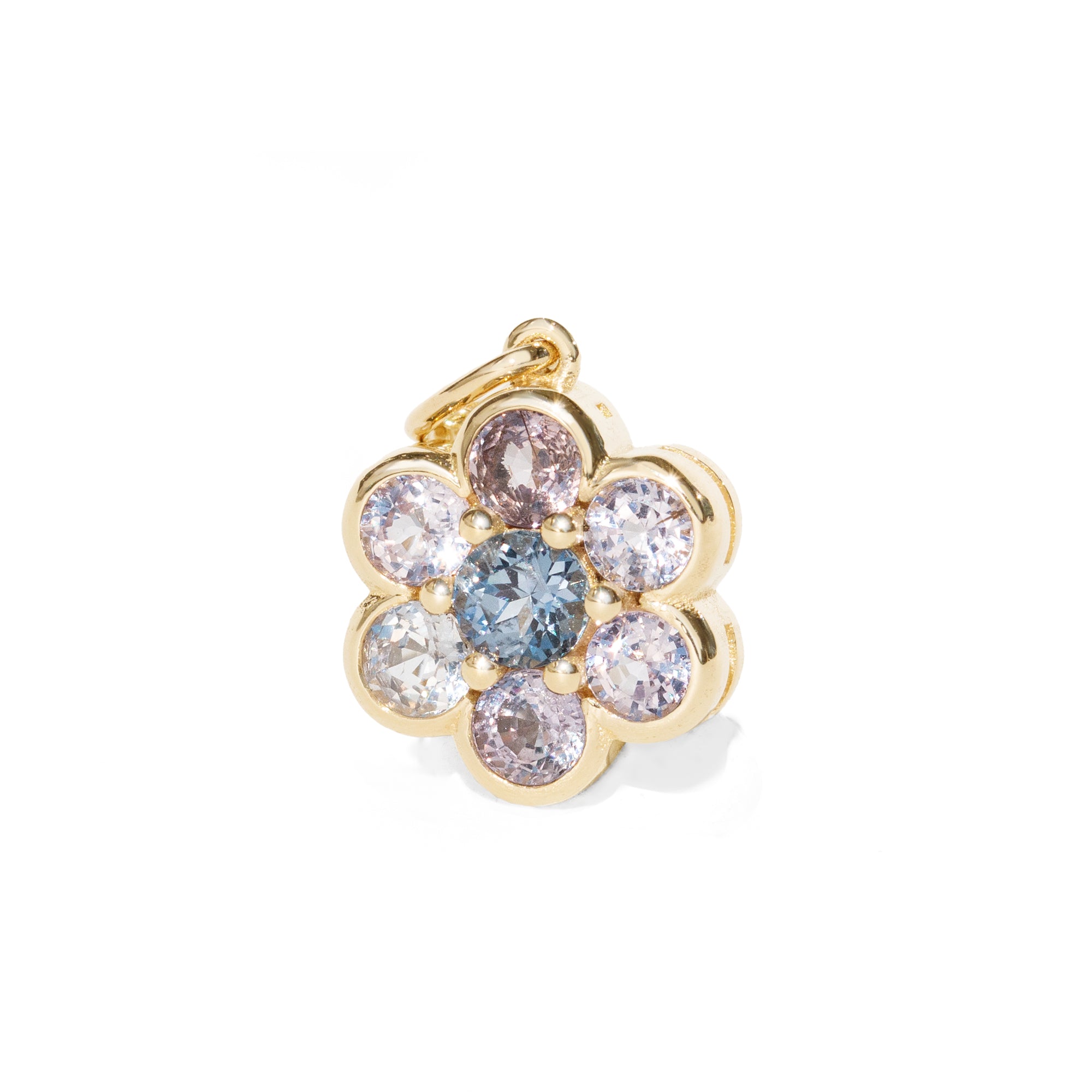 A gold flower-shaped charm pendant featuring a central round blue gemstone surrounded by six smaller round gemstones in pale pink, clear, and light blue, set in a polished gold bezel on a white background.