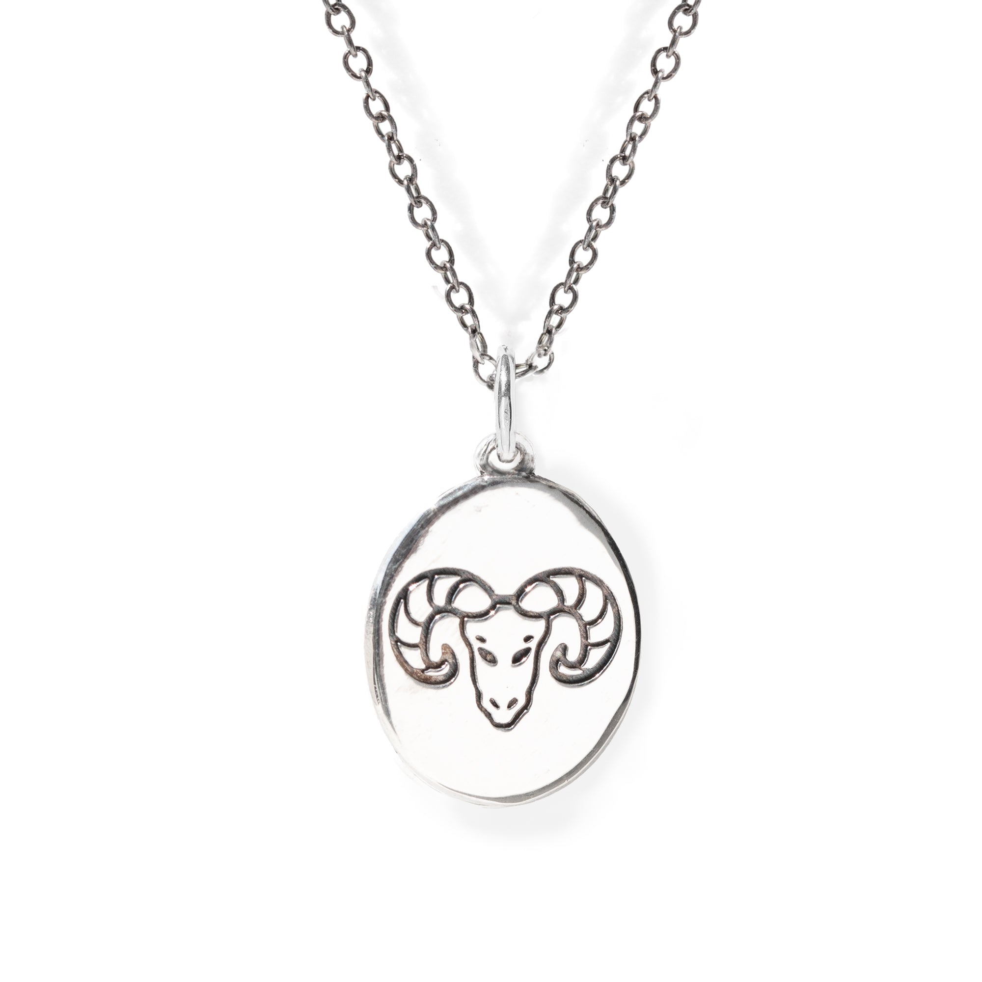 Silver necklace with a pendant featuring an engraved ram's head on a white background