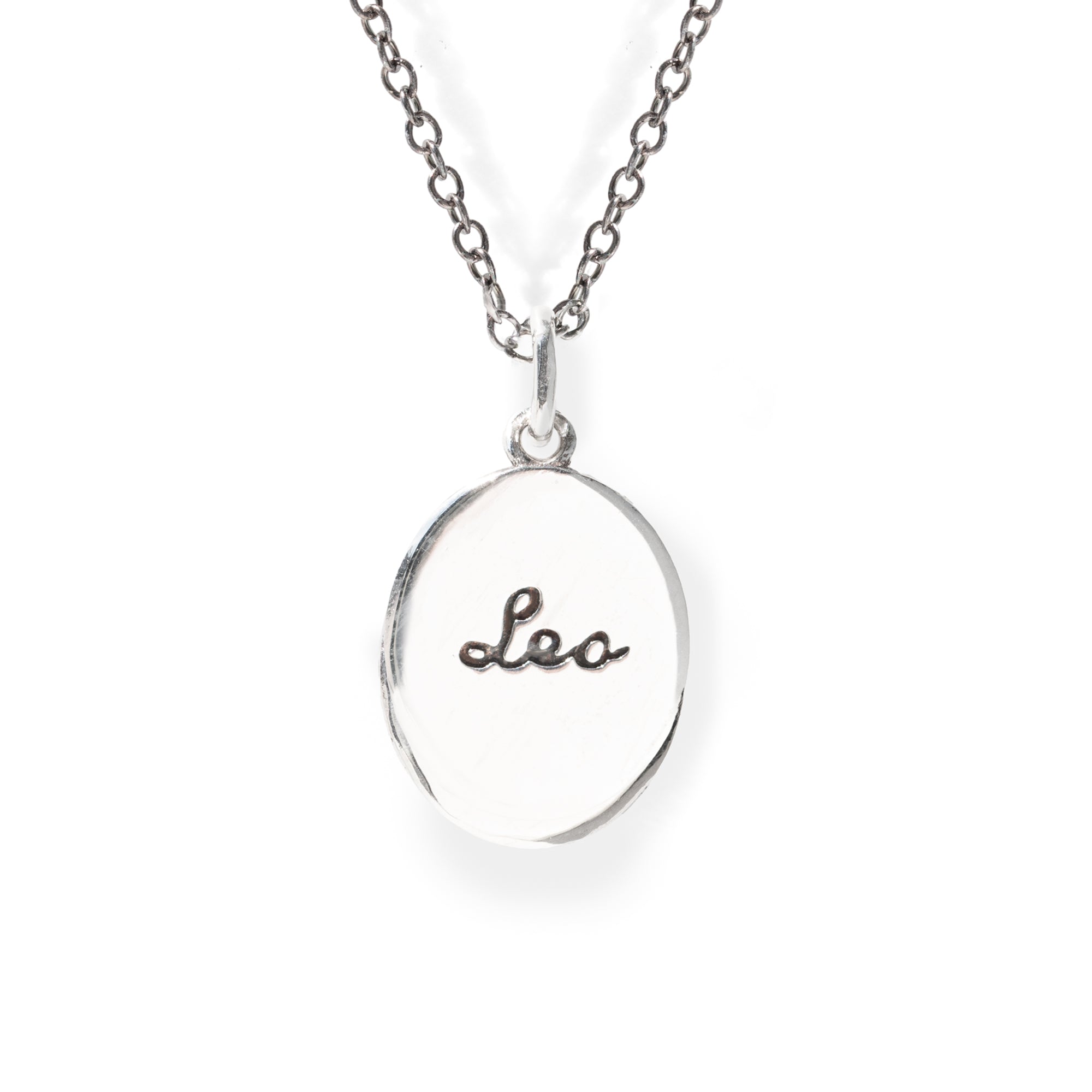 Silver necklace with a round pendant engraved with 'leo' on a white background