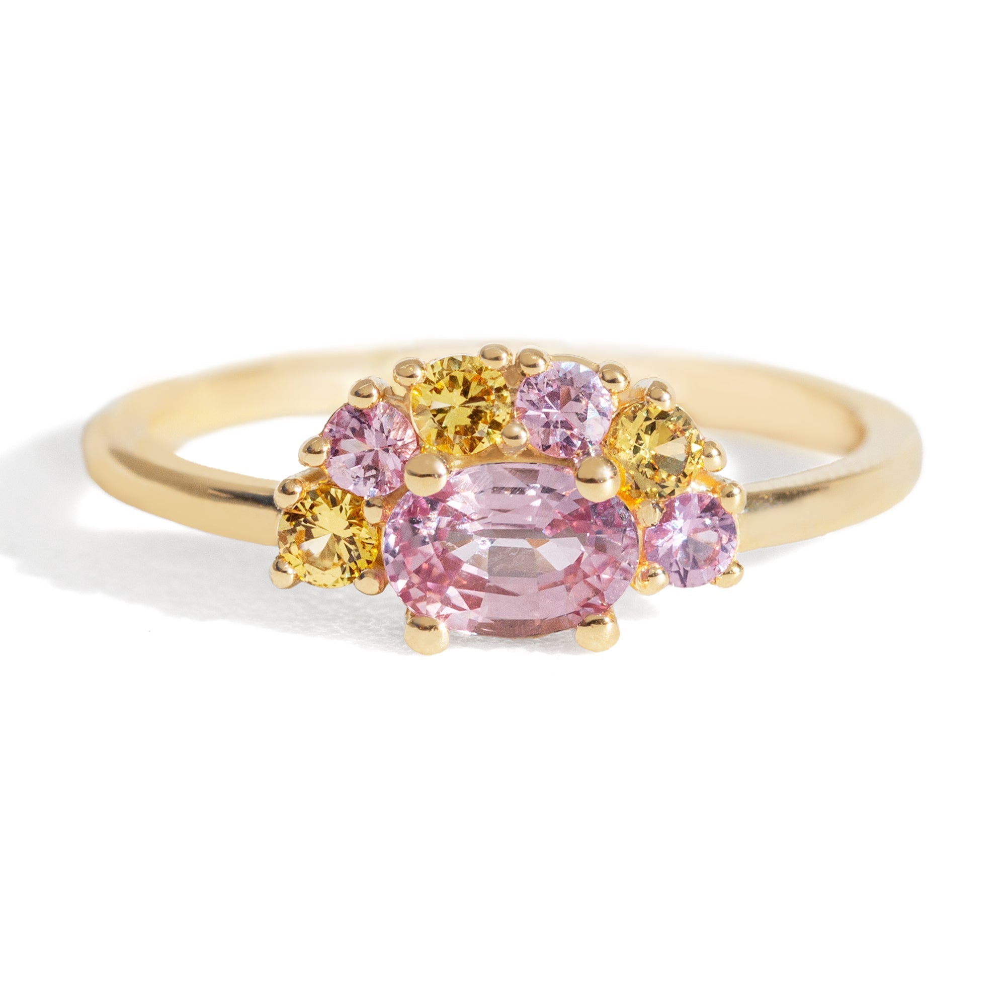 The 1.13 ctw. Pink and Yellow Sapphire Half Halo Ring features a 0.65 ct pink sapphire at its center, framed by a half halo of pink and yellow sapphires. The playful, colorful halo design is truly one of a kind. This ring is perfect for those who appreciate both colors and unique designs.