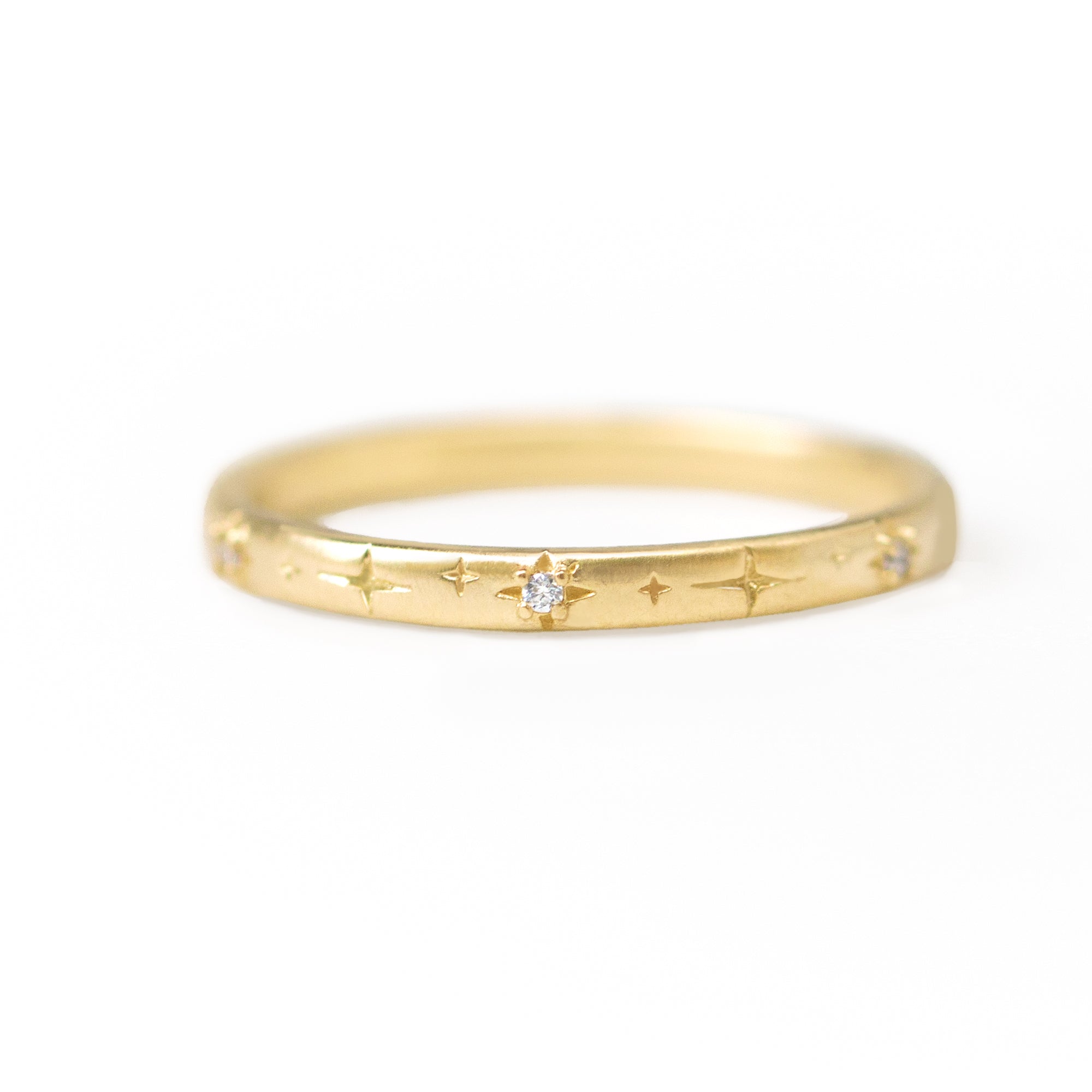 Gold ring with diamond on a white background