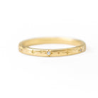 Gold ring with diamond on a white background