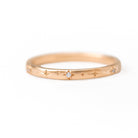 Rose gold ring with diamond on a white background