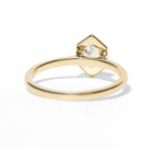 Gold ring with a diamond on a white background