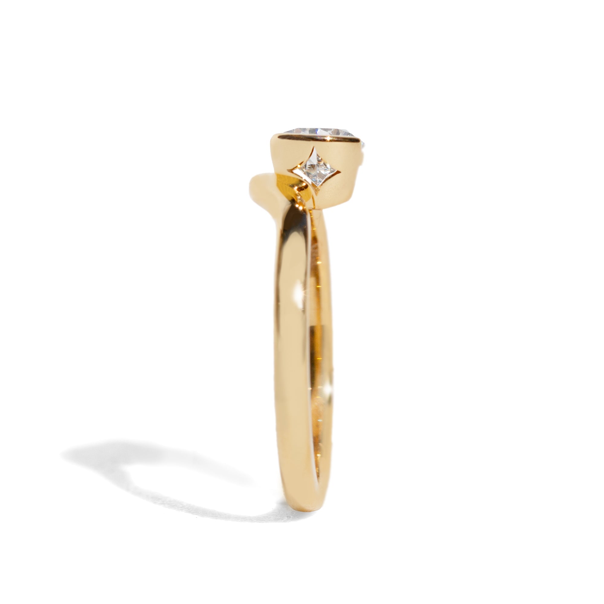 Gold ring with a diamond on a white background