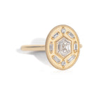 Gold ring with diamond accents around a hexagon diamond in the center on a white background
