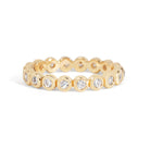 Gold ring with embedded diamonds on a white background