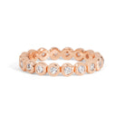 Gold ring with embedded diamonds on a white background