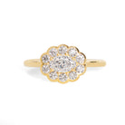 Gold ring with diamond cluster on a white background