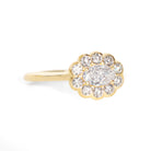 Gold ring with a diamond cluster on a white background
