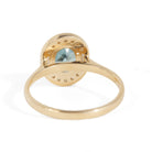 Gold ring with a blue gemstone on a white background