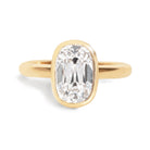 Gold ring with a large diamond on a white background