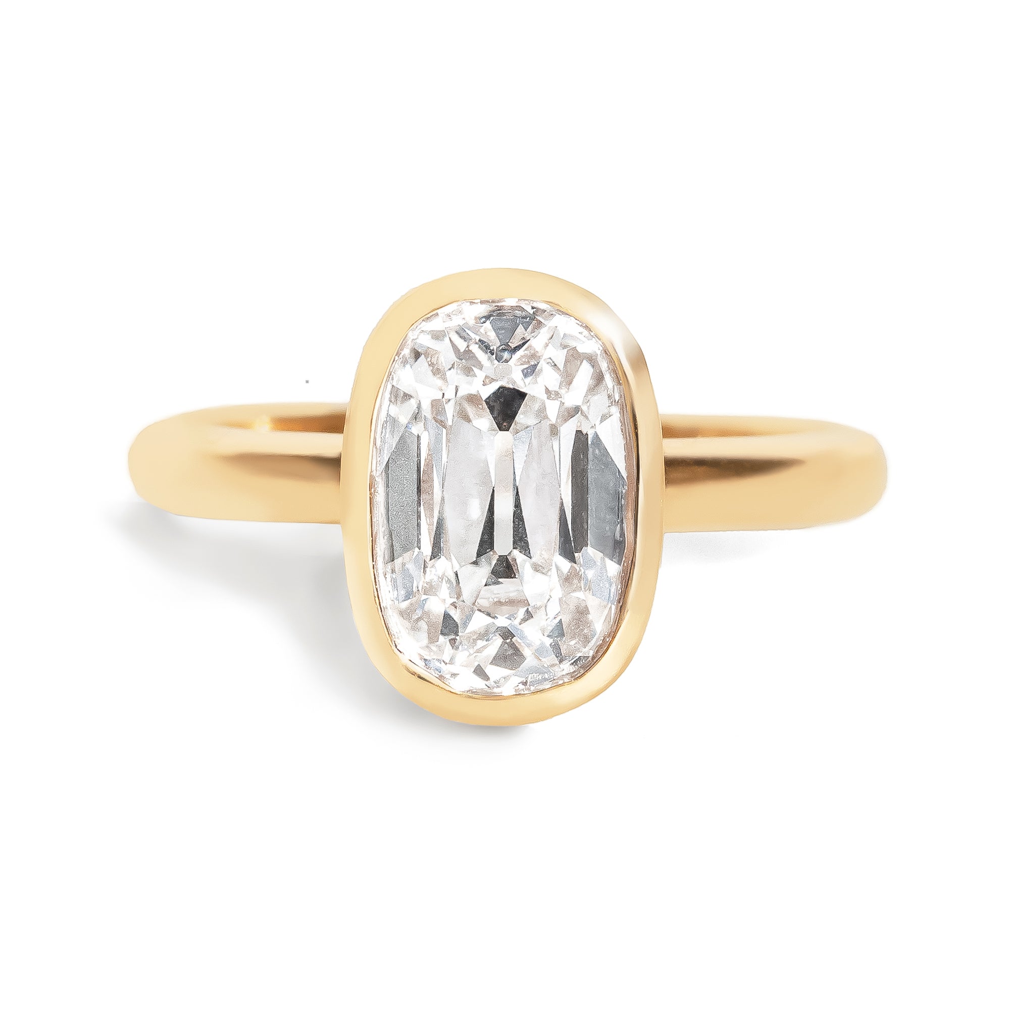 Gold ring with a large diamond on a white background