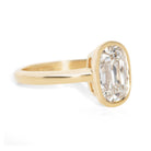 Gold bezel ring with a 2.6ct  old mine cut diamond on a white background
