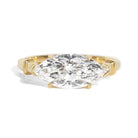 Gold ring with a large marquise shaped diamond on a white background