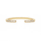 Open gold band with small diamonds on a white background