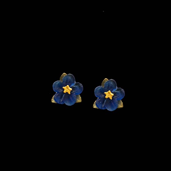 Blue flower earrings with gold accents on a black background