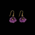 Purple flower-shaped earrings with gold accents on a black background