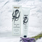 Formulary 55 Sea Salt & Lavender shea butter hand & body crème on a marble background with lavender flowers.