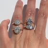 four diamonds ring on a hand against a white background